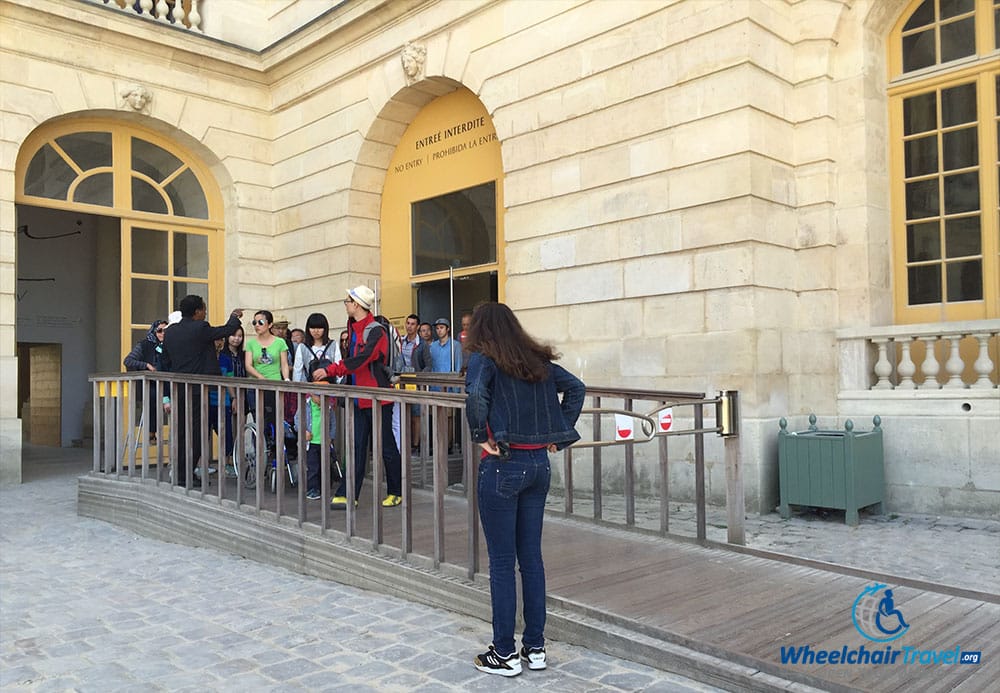 PHOTO DESCRIPTION: A wheelchair accessible ramp leading from the palace structure to an outdoor pathway.