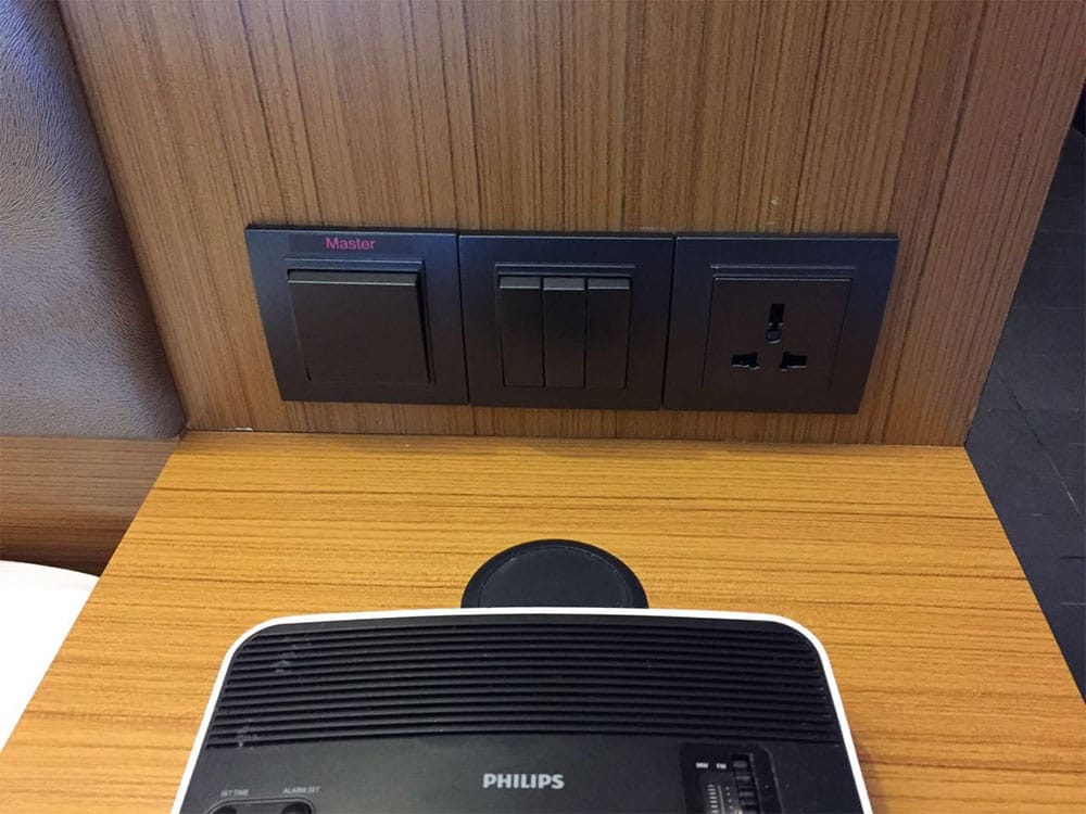 PHOTO DESCRIPTION: Power outlet above nightstand at Aloft Kuala Lumpur Sentral Hotel.