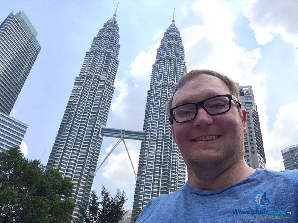 PHOTO DESCRIPTION: Selfie of John in front of the PETRONAS Twin Towers.