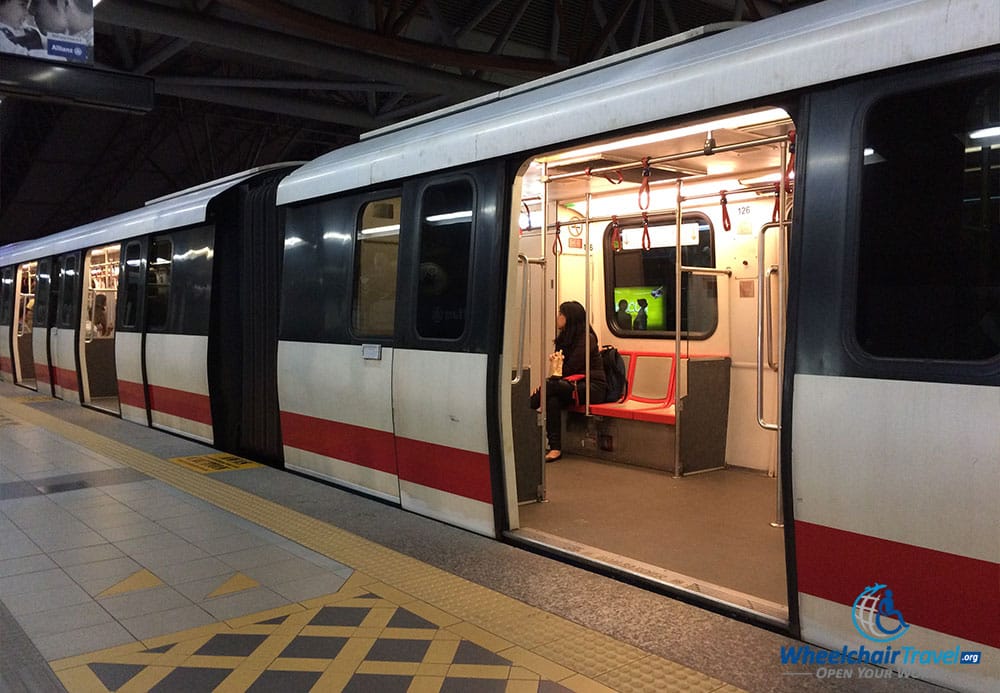 PHOTO DESCRIPTION: Light rail train stopped at station with boarding doors opened in Kuala Lumpur, Malaysia.