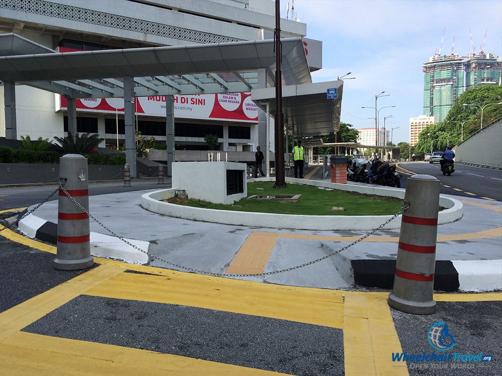 PHOTO DESCRIPTION: Sidewalk curb cut blocked by a chain in Kuala Lumpur, Malaysia.