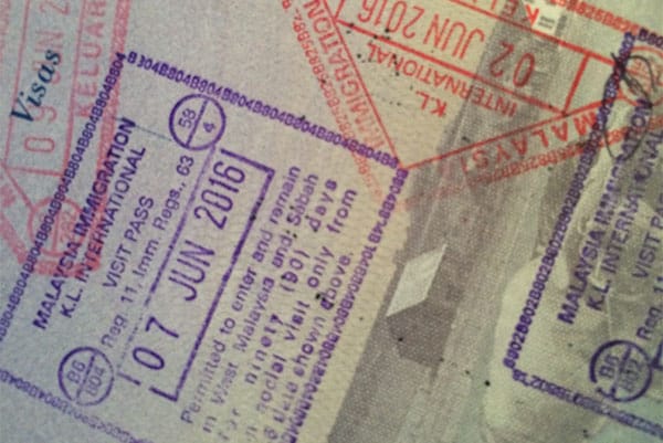 PHOTO DESCRIPTION: Malaysia entry and exit stamps in a passport.