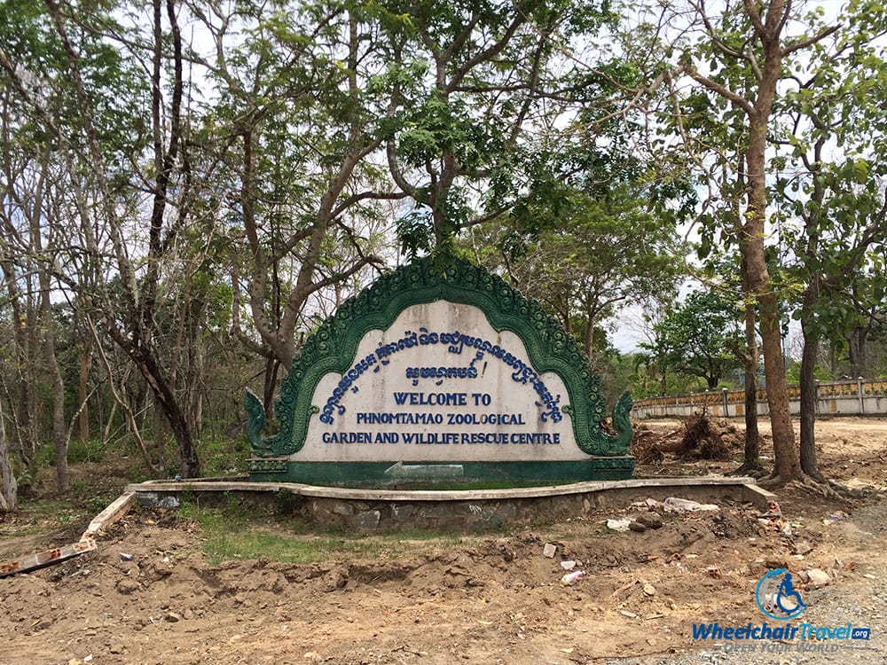 PHOTO DESCRIPTION: Sign at entrance to park that reads 'Phnom Tamao Zoological Garden and Wildlife Rescue Center'.