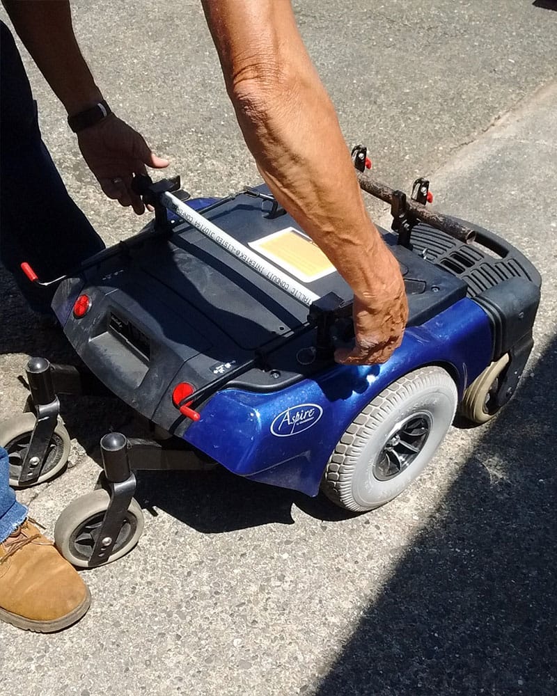 PHOTO DESCRIPTION: Disassembled power wheelchair base.