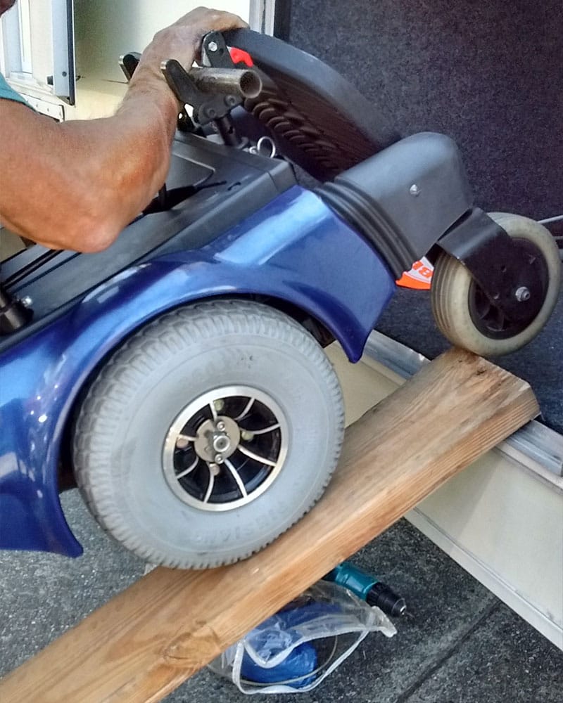 PHOTO DESCRIPTION: Power wheelchair in RV storage compartment.