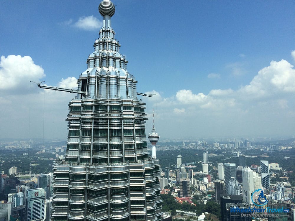 PHOTO DESCRIPTION: View from the 86th floor PETRONAS Twin Towers observation deck, with the tip of tower 1 visible and the KL Tower in the distance.