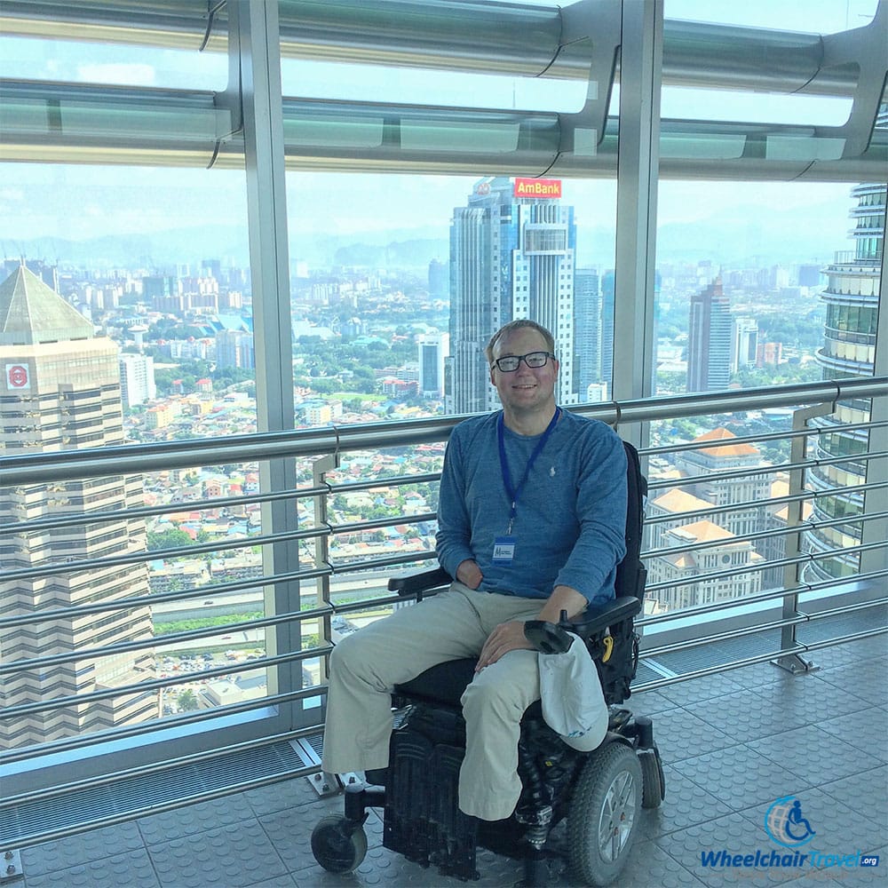 PHOTO DESCRIPTION: Wheelchair user John Morris on the PETRONAS Twin Towers Skybridge.