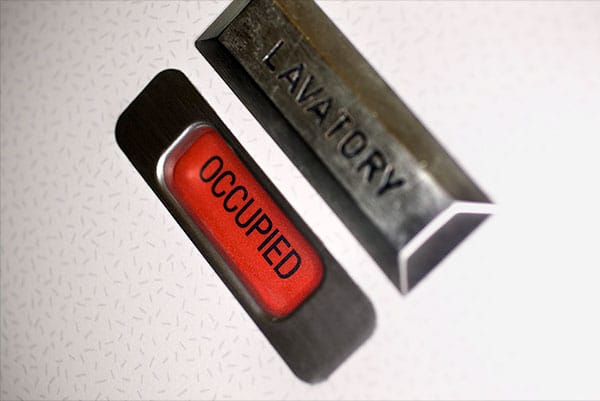 PHOTO DESCRIPTION: Occupied sign on door of airplane lavatory.