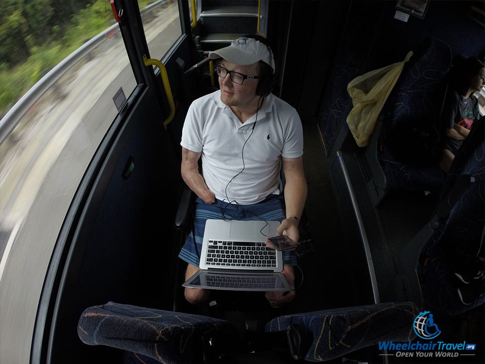 Wheelchair user seated in personal wheelchair on Megabus bus.