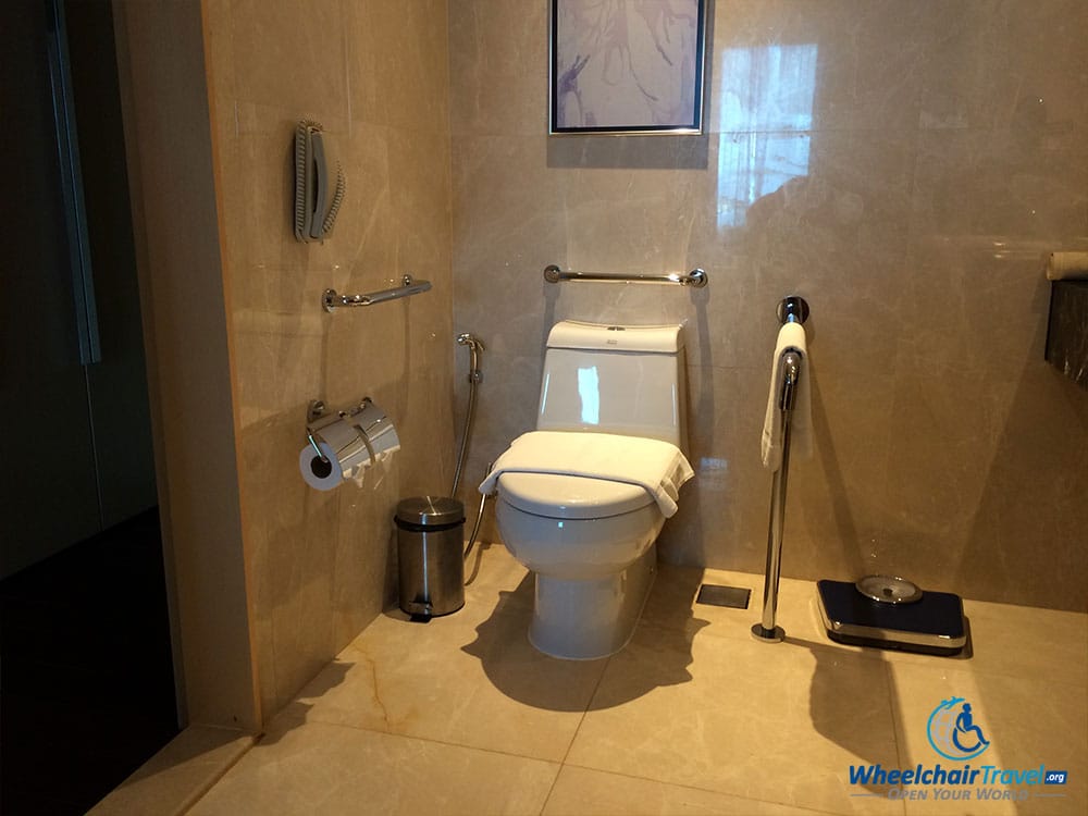 PHOTO DESCRIPTION: Toilet in wheelchair accessible hotel room.