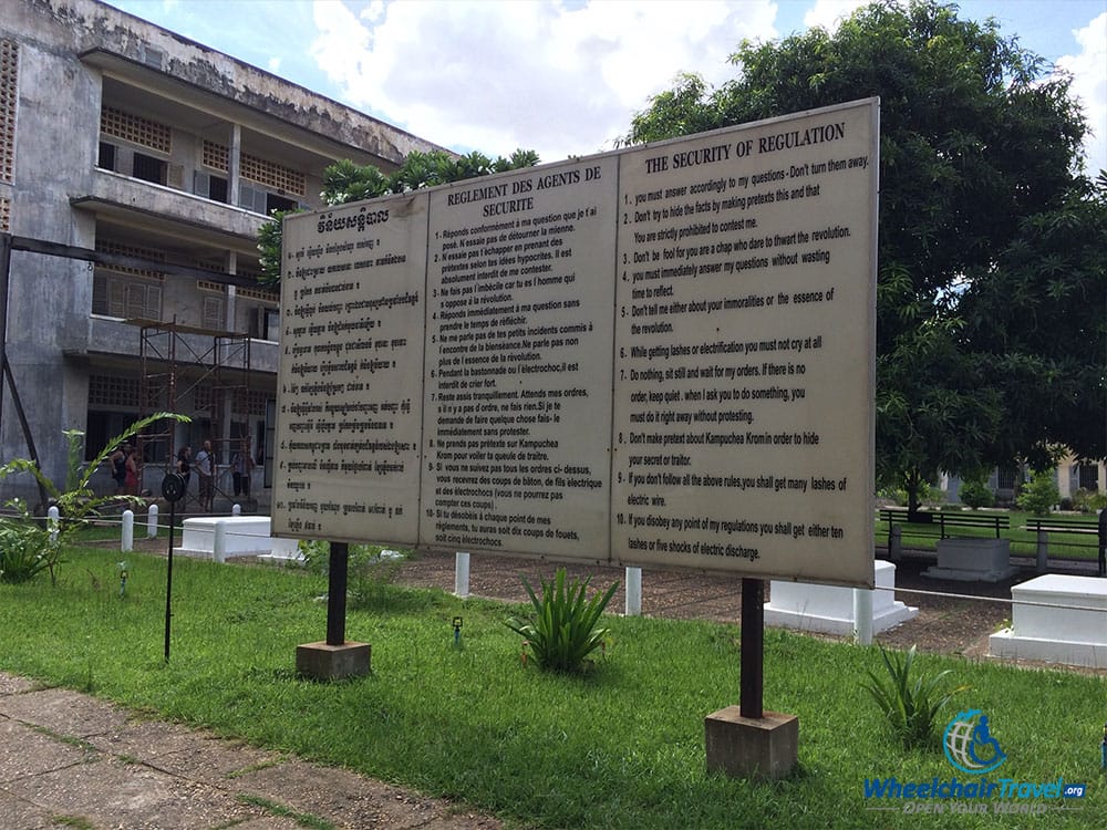 PHOTO DESCRIPTION: The camp's 10 rules for behavior posted on a sign just inside the prison gate.