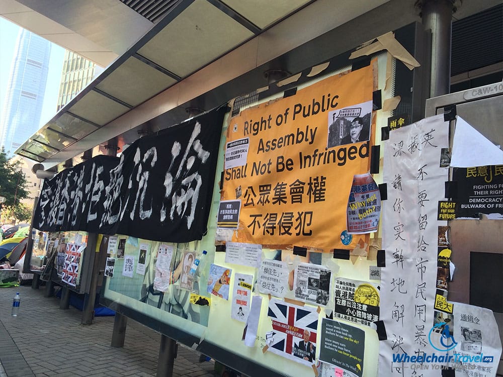 PHOTO DESCRIPTION: Umbrella Movement signs posted on a board in Hong Kong.