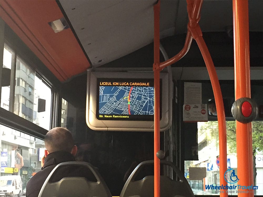 PHOTO: Interior of a Bucharest city bus, with video screen showing the bus location and route information.