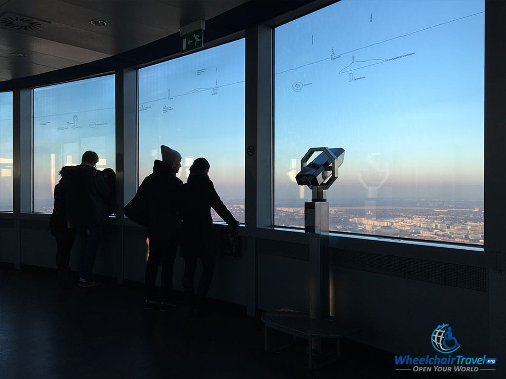 PHOTO DESCRIPTION: Observation deck with large windows and a clear view of the afternoon sky.