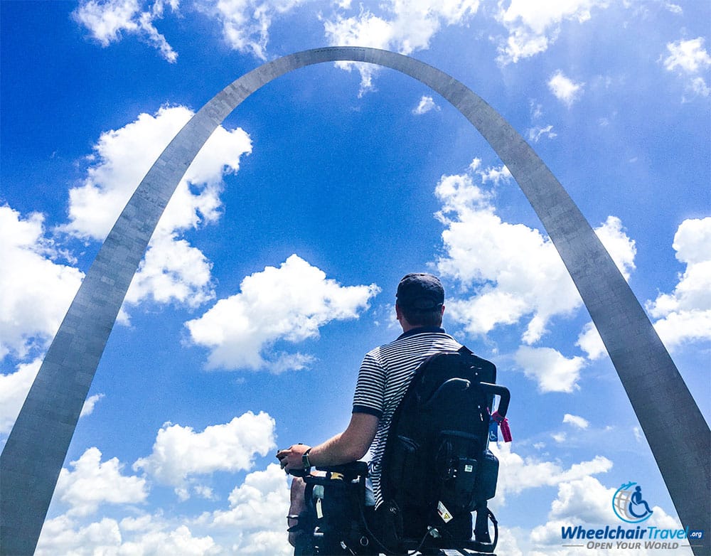 Wheelchair user John Morris in front of the St. Louis Arch.