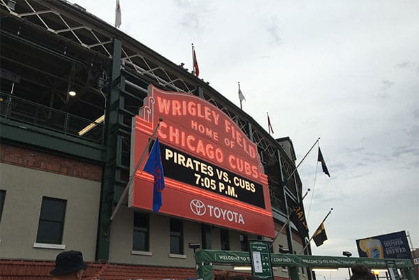 PHOTO: Exterior of Chicago Cubs Wrigley Field, with a board announcing the opponent and game time.