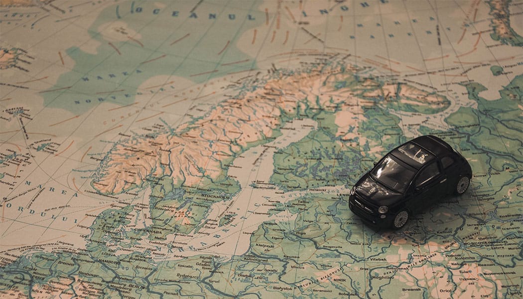 PHOTO: Toy car set atop a large world map.