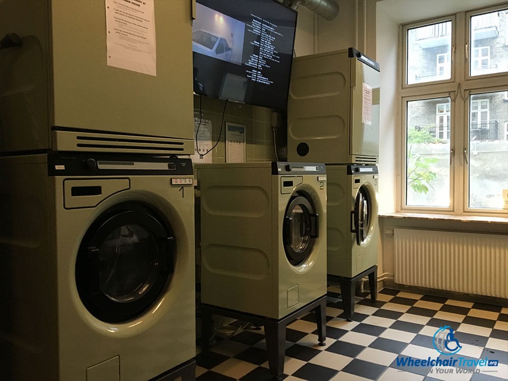 Laundry room with washers and dryers at Urban House Hostel.