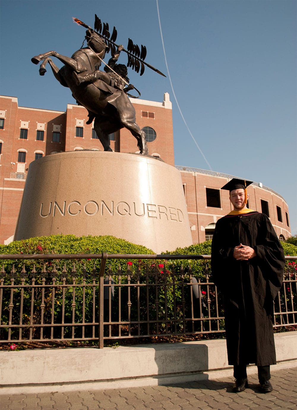 PHOTO: John outside Doak Campbell Stadium, for a graduation photo op in 2012.