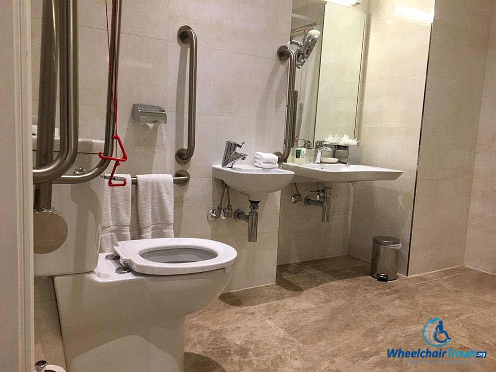 Wheelchair accessible toilet and bathroom sink at Hilton London Paddington hotel