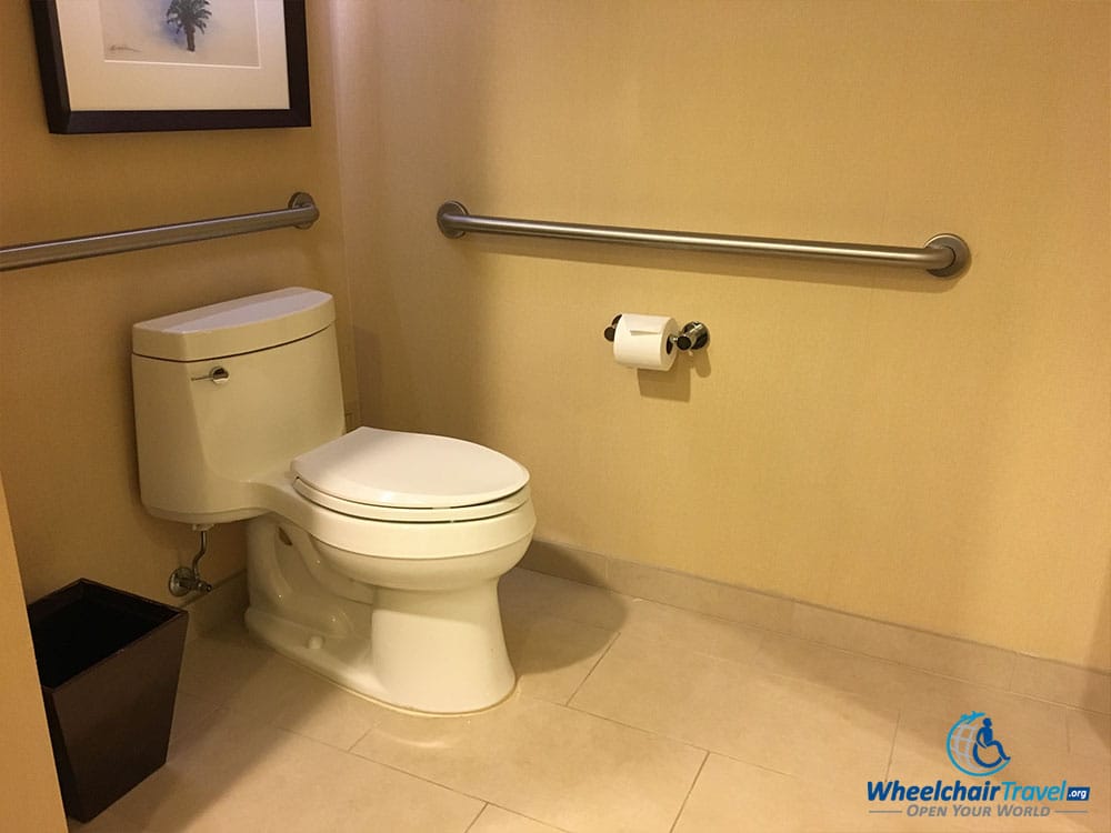 Wheelchair accessible toilet with grab bars.