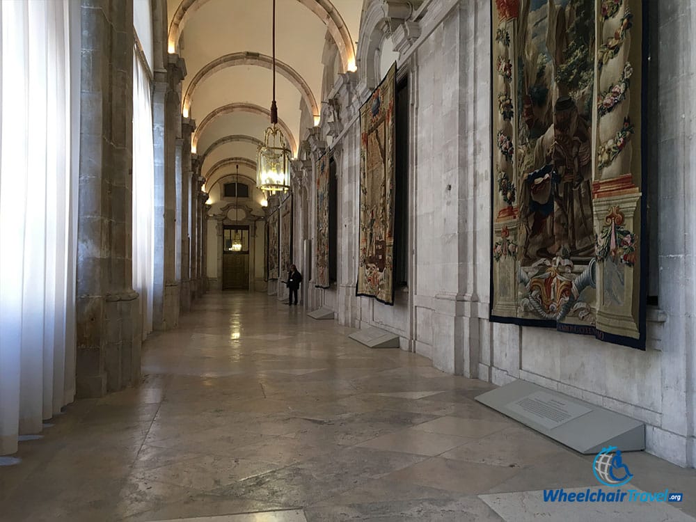 Hallway lined with hanging tapestries