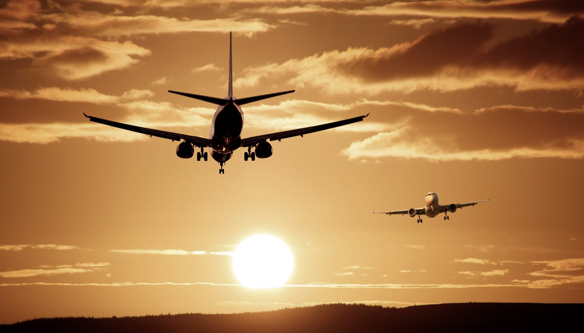 Airplanes against a sunset sky