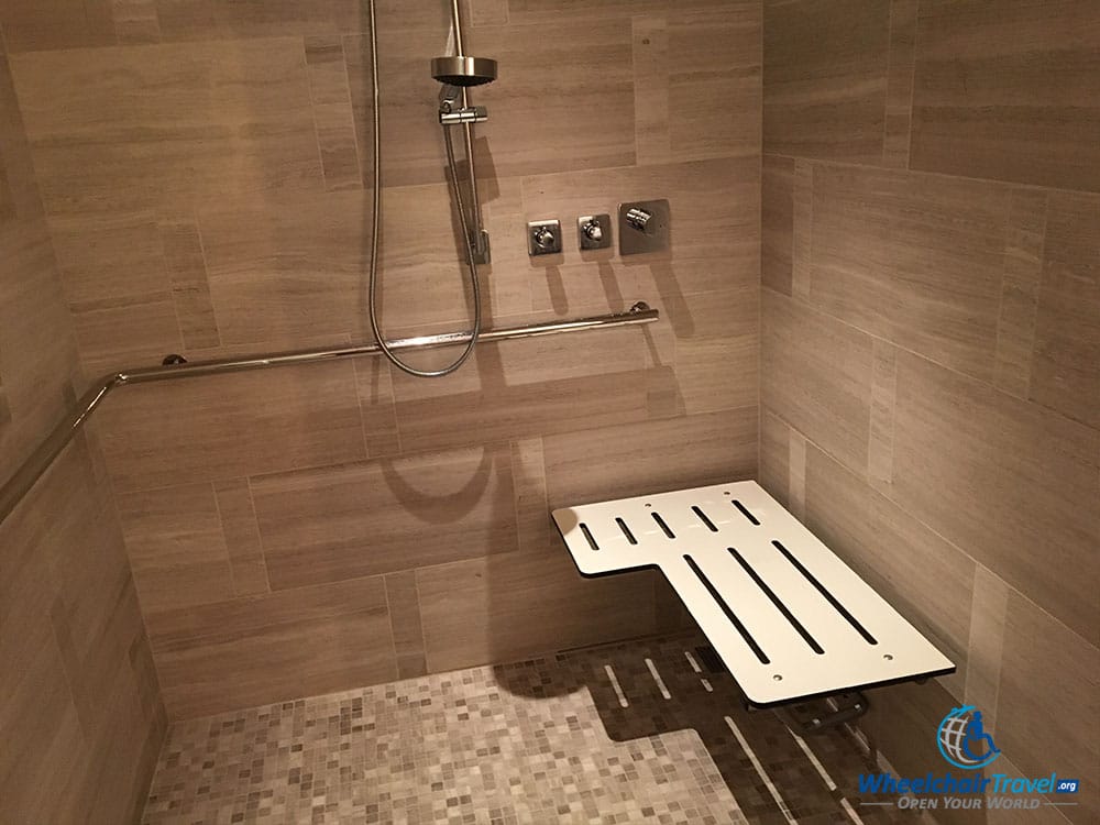 Roll-in shower with built-in bench and grab bars