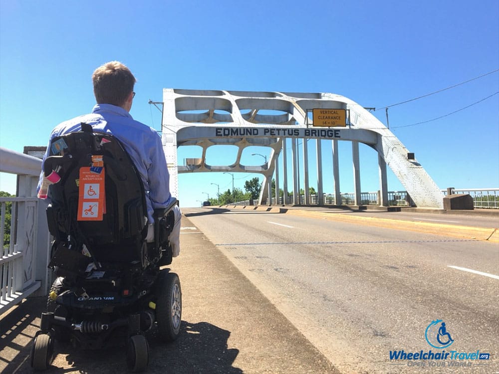 John Morris, in a wheelchair, looking towards the Edmund Pettus Bridge