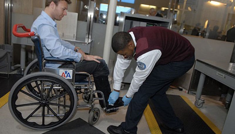 Wheelchair user receiving patdown at TSA airport security