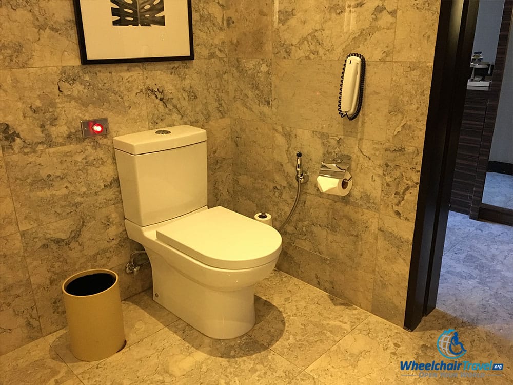 Toilet in wheelchair accessible bathroom.