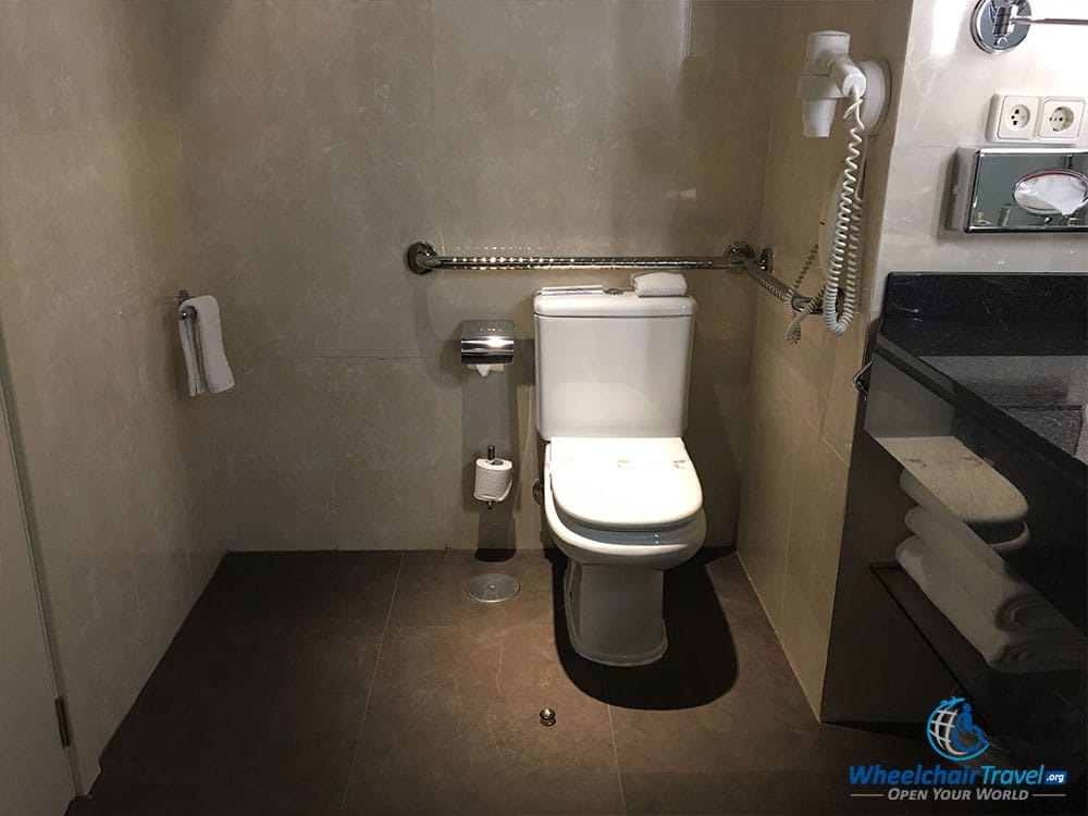 Handicap accessible toilet with grab bars.