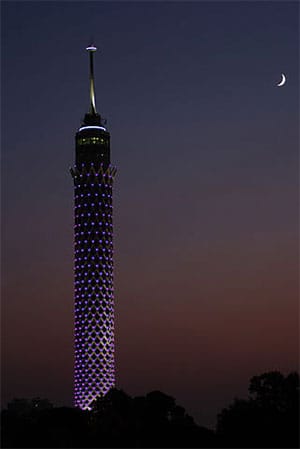 Cairo Tower lit up at night.