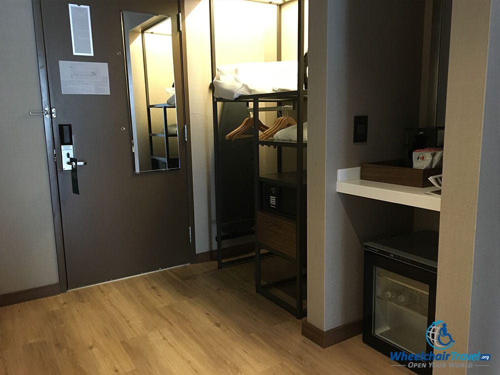 Guest room entryway with an accessible closet and other features.