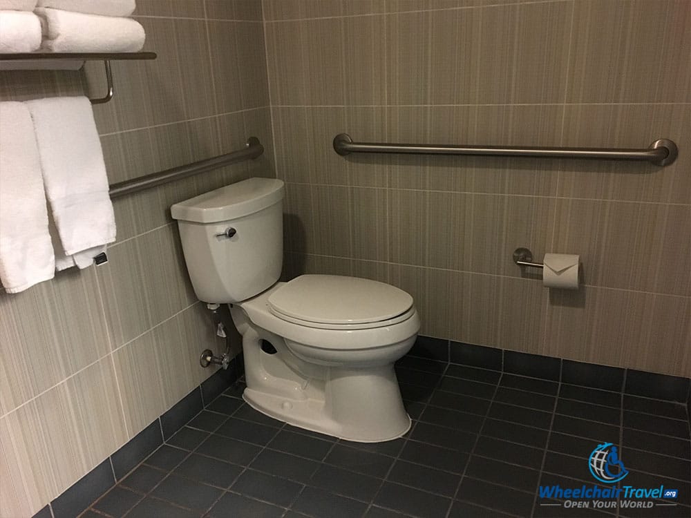 Accessible toilet with grab bars.