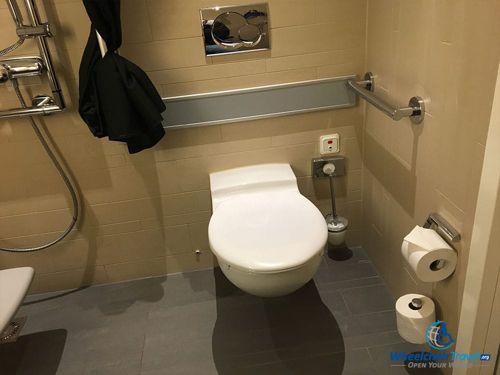 Wheelchair accessible toilet with grab bars.