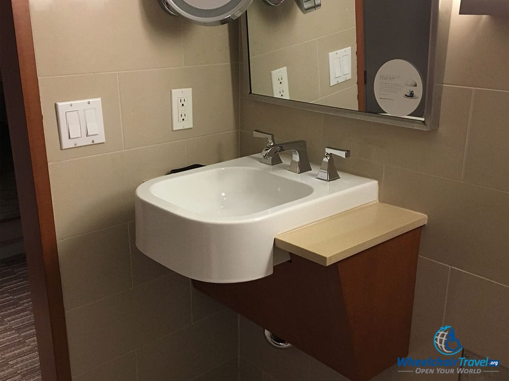 Bathroom sink with angled mirror.