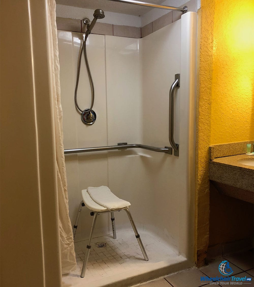 Shower in accessible hotel room at Days Inn Orlando International Drive.