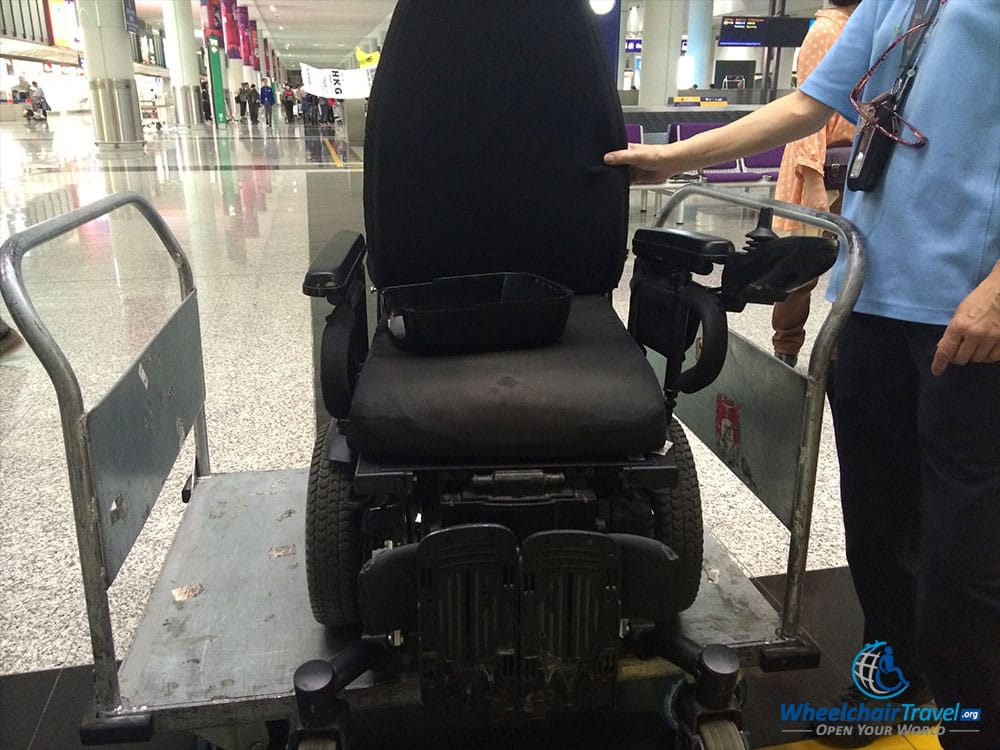 Power wheelchair returned at Hong Kong Airport baggage claim.