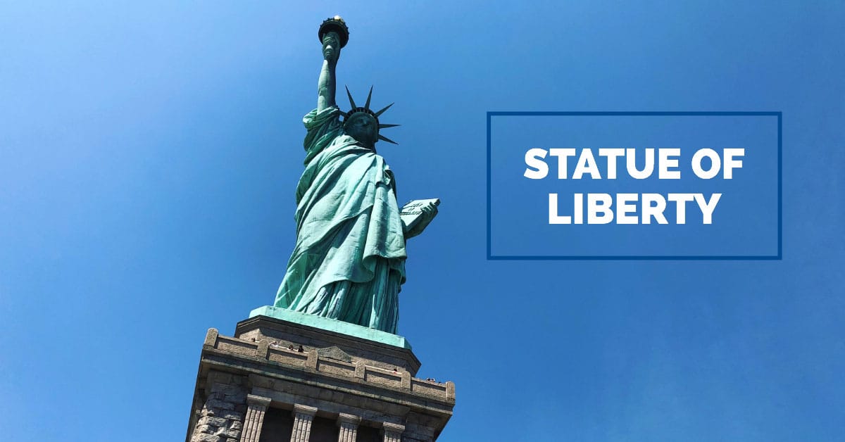 The Statue of Liberty against a clear blue sky.