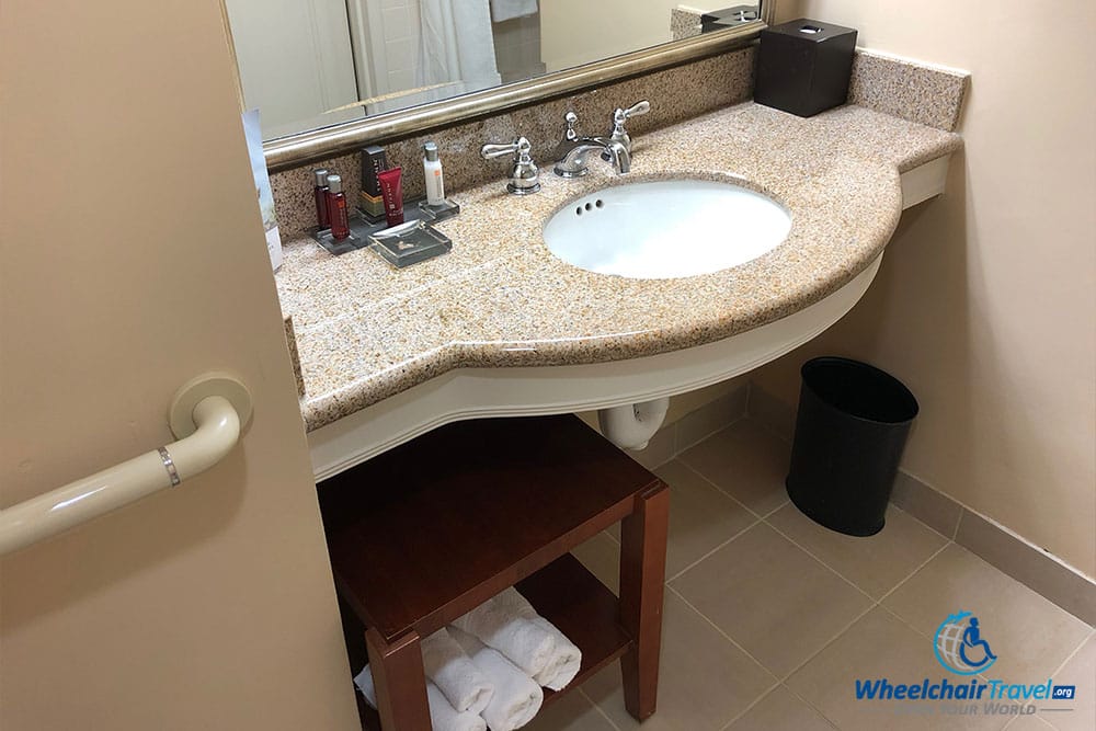 Bathroom sink with space for wheelchair.