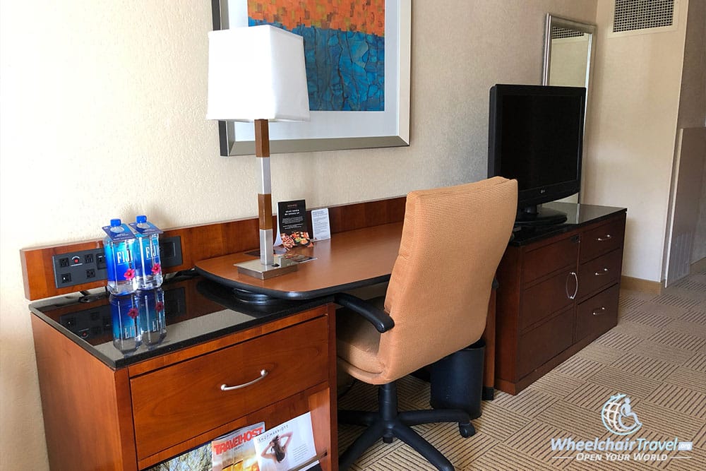 Accessible work desk with a rolling chair.