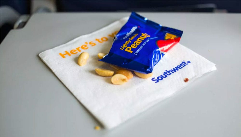 Peanuts on an airplane tray table.