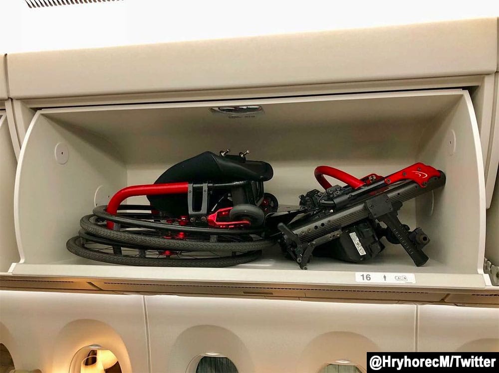 Power wheelchair stored in airplane's overhead bin.