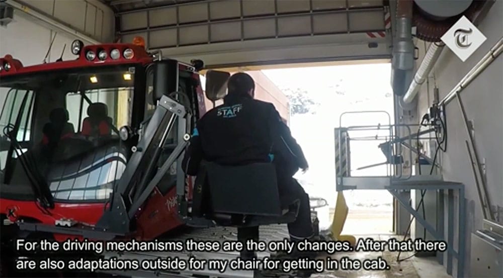 Man uses lift to access seat in tractor.