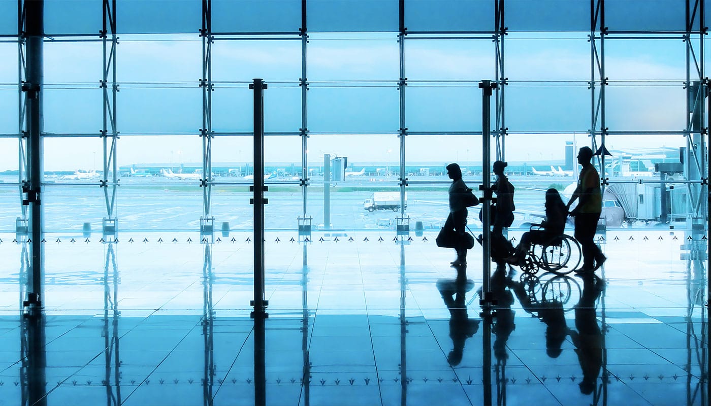 Airline passenger with a wheelchair in the airport terminal.