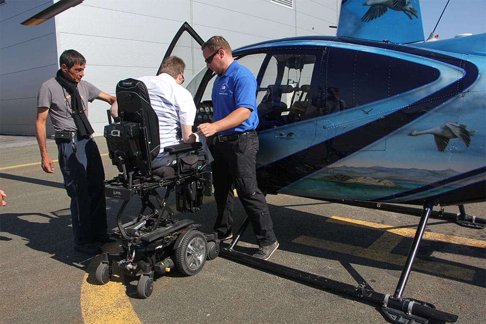 Preparing to transfer into the helicopter seat.