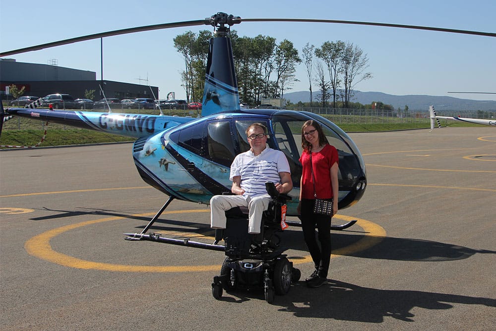 Posing for a photo with the Robinson R44 helicopter.