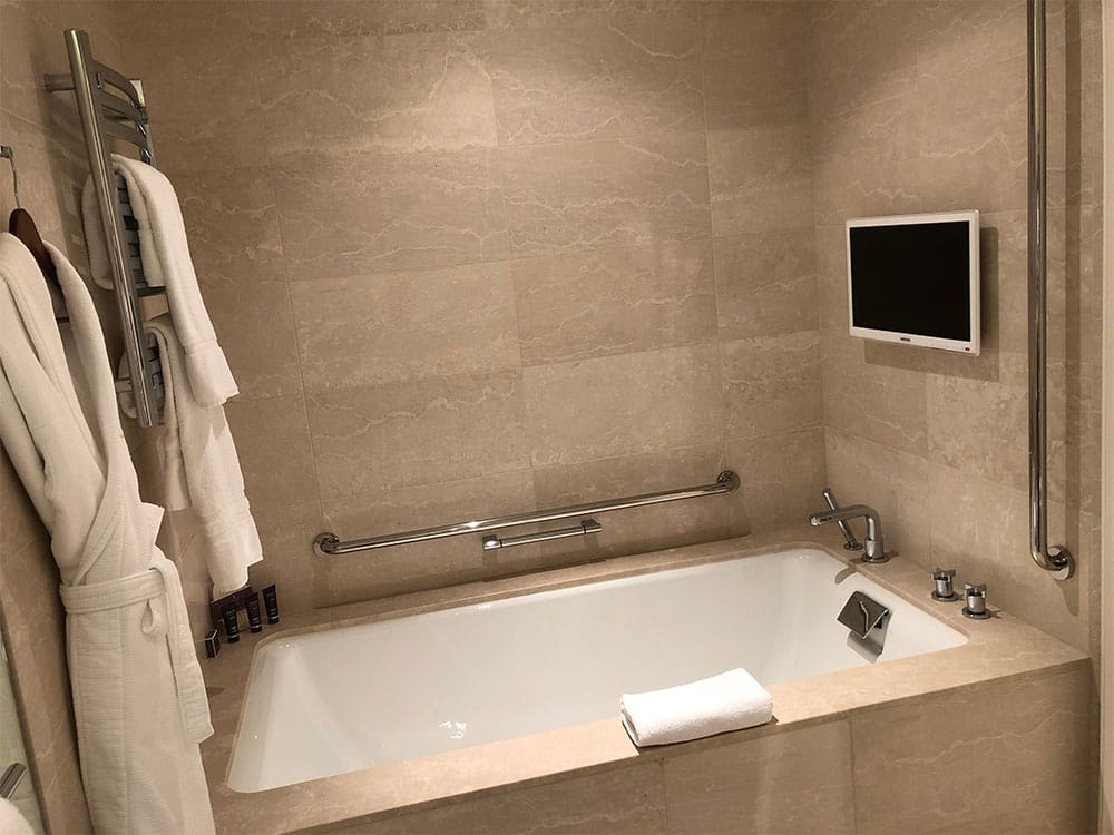 Large soaking bathtub with grab bars.