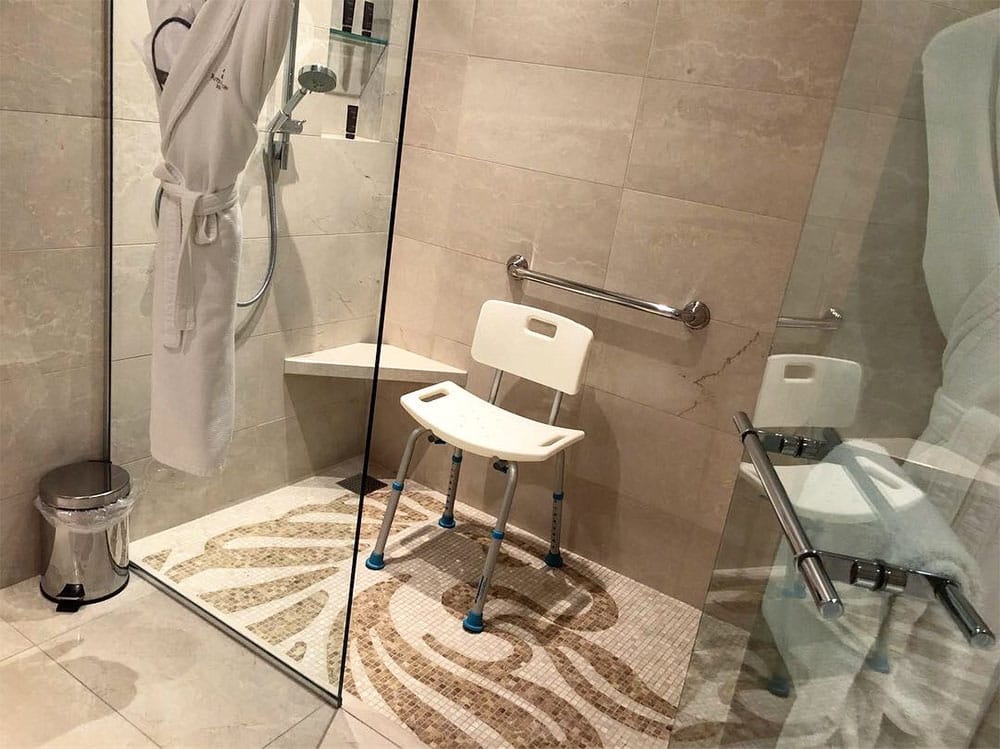 Roll-in shower with a glass door.